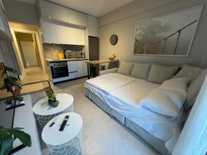 a bedroom with a large bed and a kitchen at Eleni Siviri in Siviri