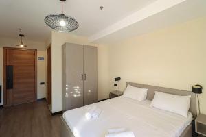 a bedroom with a large white bed with white pillows at Apartment in Marshall Gudauri Project in Gudauri