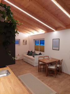 a living room with a table and a couch at Ferienwohnung Zimmerle in Pflach +7 photos