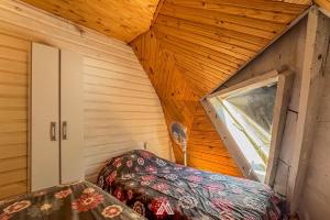 an attic room with a bed and a window at SAGRADAS de LA PALOMA in La Paloma +69 photos