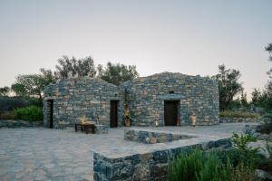 a stone building with a table in front of it at Village Heights Resort in Hersonissos