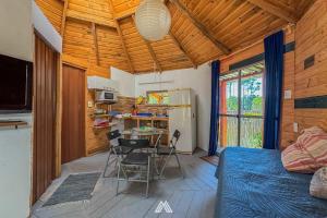 a room with a bed and a table and chairs at SAGRADAS de LA PALOMA in La Paloma