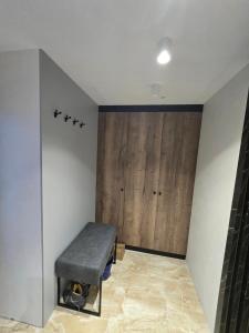 a room with a bench and a wooden wall at Lu and Ma in Jahorina