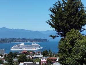a cruise ship in a large body of water at Cabañas Cristóbal in Puerto Montt