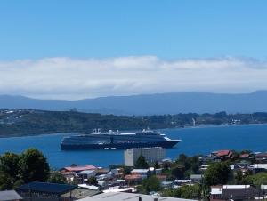 a large cruise ship in a large body of water at Cabañas Cristóbal in Puerto Montt +3 photos