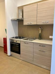 a kitchen with a sink and a stove at Leopoldo in SantʼAnastasia +15 photos