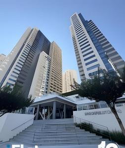two tall buildings with stairs in front of a building at Espaço e Vista Brookfield Towers in Goiânia