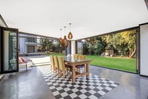 - une salle à manger avec une table et des chaises sur un sol en damier dans l'établissement The Urban Sanctuary Boutique Hotel & Retreat, à Johannesbourg