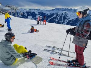 a group of people on top of a ski slope at Appartement Pension Embacher in Viehhofen