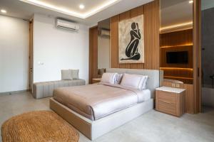 a bedroom with a bed and a television in it at AZORA VILLAS - Bali Invest Club in Tumbak Bayuh +27 photos