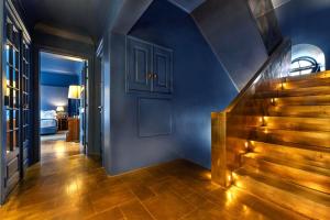 a hallway with blue walls and stairs and a blue door at Villa Cascais Boutique Hotel in Cascais
