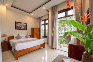 Postel nebo postele na pokoji v ubytování Phuoc Dat Riverside Homestay Hoi An + 37 fotografií