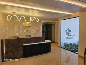 a lobby with a mount manager sign on the wall at Mount Manor in Chennai