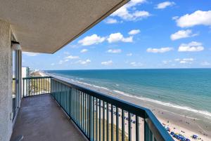 a balcony with a view of the beach at 4BR Oceanfront Corner Condo NMB in Myrtle Beach