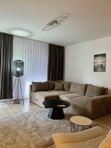 a living room with a couch and a table at Kleon Apartament in Pristina