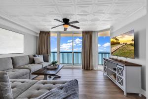 a living room with a couch and a ceiling fan at 4BR Oceanfront Corner Condo NMB in Myrtle Beach