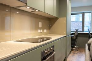 a kitchen with a stove and a counter top at Practical Room For One, Central Nottingham in Nottingham