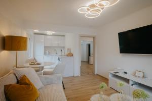 a living room with a couch and a dining room at Ferienwohnung De luxe Kramer in Sattendorf