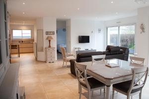 a living room with a table and a couch at Maison de vacances bord de mer in Pornichet