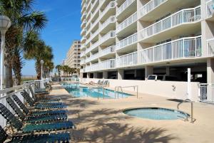 a swimming pool in front of a large apartment building at Crescent Shores North - 502 in Myrtle Beach