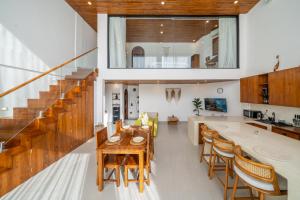 a kitchen and living room with a table and chairs at Darina - Brand-New Villa Just Minutes from the Beach with a Huge Pool in Badung