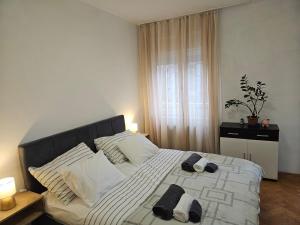 a bedroom with a large bed with towels on it at Apartman Judita in Zagreb