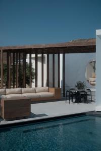 a living room with a couch and a pool at PNOĒS Tinos in Tinos Town