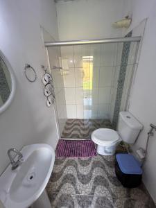 a bathroom with a shower and a toilet and a sink at Hospedagem Portal da Terra in São João +15 photos