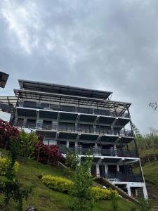 a large building with balconies on the side of it at Hotel Curazao Natural Living in Cocorná