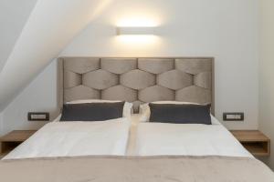 a bedroom with a large bed with a large headboard at Apartma pri Hrvatu in Bohinj