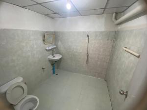 a bathroom with a toilet and a sink at PTT Mansion ปทิตา แมนชั่น in Ban Zong Katiam +11 photos