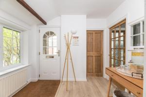 a room with a white door and a table at Central Malham Wellbeing Escape, 5-bed house with yoga studio in Malham +21 photos