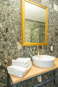 a bathroom with a sink and a mirror at Epic rooms in Braşov