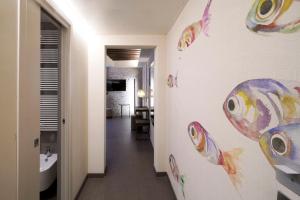 a bathroom with a wall with fish stickers on it at Hotel Aquarius Venice - Ascend Collection in Venice