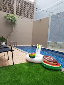 una piscina con dos donuts inflables y una piscina inflable en Villa Neona Nora, en Tlekung 20 fotos más