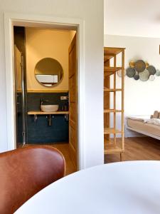 a bedroom with a bathroom with a sink and a mirror at Nomad Nest in Michelbach an der Bilz