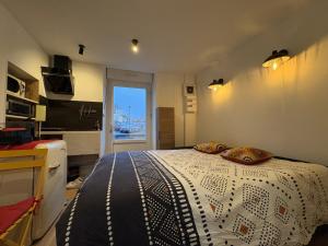 a bedroom with a bed with two pillows on it at Petite merveille in Vittel