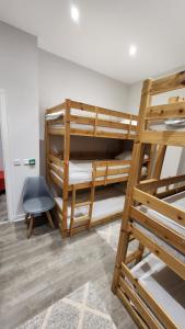 a room with two bunk beds and a chair at Just Sleep Hostel Edinburgh in Edinburgh