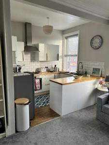 a kitchen with white cabinets and a counter top at 1 bedroom spacious apartment in Lytham St Annes