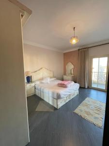 a bedroom with a bed and a window at The Grand Penthouse in Cairo