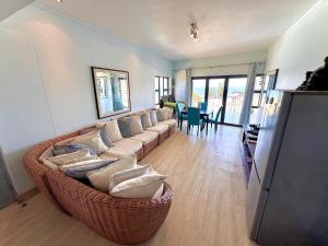 a living room with a large couch with pillows at Whale Rock Unit 8 in Margate