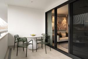 a dining room with a white table and chairs at Olive Suite - Dunsborough Centre in Dunsborough
