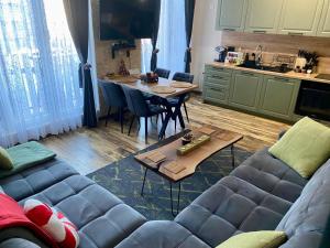 a living room with a couch and a table at Mavrovo_apt4 in Mavrovo +8 photos