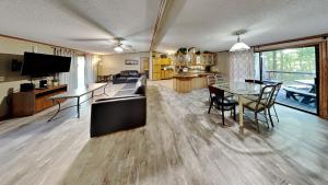 a living room and dining room with a table and chairs at Island Club #98 in Put-in-Bay