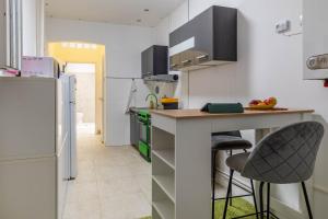 a kitchen with a counter and two bar stools at Varkert Green 16 in Budapest +2 photos