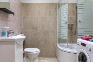 a bathroom with a toilet and a sink and a shower at Varkert Green 16 in Budapest