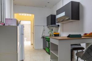 a kitchen with a counter and a refrigerator at Varkert Green 16 in Budapest