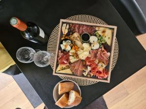a table with a plate of pizza and a bowl of bread at Les Suites de Bougainville in Concarneau