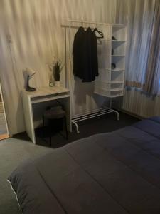 a bedroom with a bed and a dresser and a desk at 1-2 P Room near Airport AMS freeparking in Roelofarendsveen
