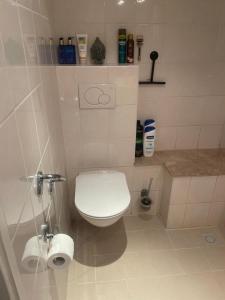 a white bathroom with a toilet and a sink at 1-2 P Room near Airport AMS freeparking in Roelofarendsveen